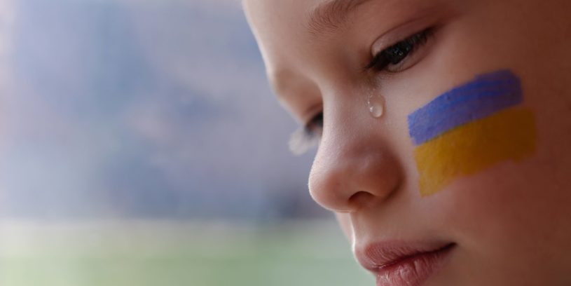 A,Child,With,The,Flag,Of,Ukraine,Is,Crying.,Sadness